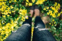 Kaboompics - Woman with vintage camera in the field of blooming rapes