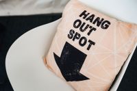 Kaboompics - Decorative Pillow with Hang Out Spot Typography