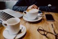 Kaboompics - Cup of coffee & MacBook laptop, glasses, iPhone mobile phone on table in cafe