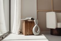 Kaboompics - Neutral Interior with Upholstered Armchair, Open Book and Stone Sculpture