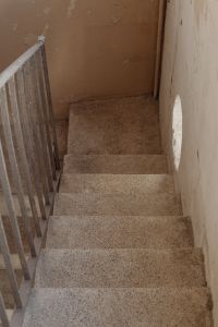 Kaboompics - Narrow Terrazzo Stairwell with Metal Railing and Arched Opening