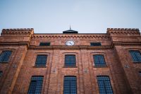 Kaboompics - Historic Brick Facade with Clock and Tall Windows
