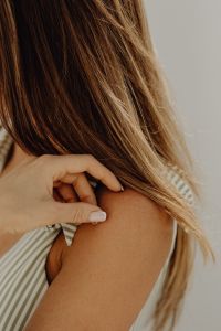 Kaboompics - Close-Up of a Hand Adjusting a Striped Swimsuit Strap