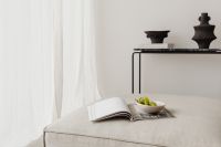 Kaboompics - Beige Linen Sofa with Open Magazine and Bowl of Green Grapes