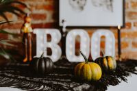 Kaboompics - Mini Pumpkins in Front of a Glowing Halloween BOO Sign