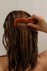 Kaboompics - Woman Detangling Wet Hair with a Comb