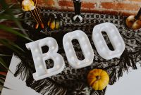 Kaboompics - Overhead Halloween BOO Sign on Black Lace with Mini Pumpkins