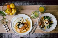 Kaboompics - Overhead Healthy Dinner Flat Lay with Salmon, Goat Cheese Salad, Citrus and Fresh Juice