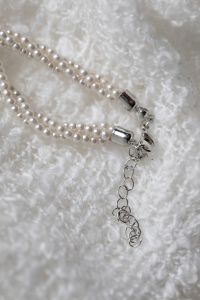 Kaboompics - Pearl Necklace Clasp and Extension Chain on White Blanket