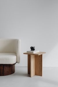 Kaboompics - Bouclé Armchair and Oak Side Table with Black Knot Sculpture
