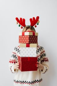 Kaboompics - Woman in Reindeer Antlers Hidden Behind a Stack of Gifts