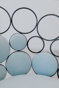 Kaboompics - Modern Lounge Chair with Circular Backrest and Light Blue Upholstered Panels