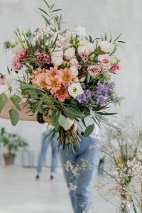 Kaboompics - Man Holding a Bouquet in an Ornate Mirror Reflection, Floral Portrait