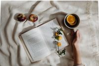 Kaboompics - Open Book With Orange Tea and Yellow Flowers