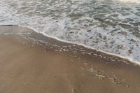 Kaboompics - Foamy Baltic Sea Waves Washing Over Wet Sand, Coastal Texture