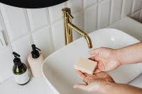 Kaboompics - Bar Soap Resting in Wet Hands at a White Sink, Handwashing Tutorial and Hygiene Content