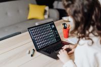 Kaboompics - Woman Typing on Laptop at Wooden Table