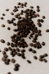 Kaboompics - Roasted Coffee Beans Scattered on Light Background