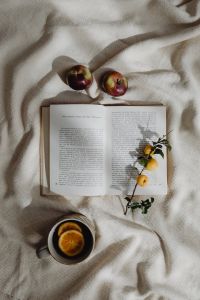 Kaboompics - Open Book With Orange Tea and Autumn Flowers