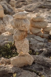 Kaboompics - Gold Necklace Draped over a Limestone Rock Cairn