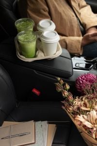 Kaboompics - Woman Holding a Matcha and Coffee Drink Carrier in a Car