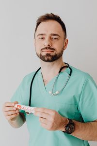 Kaboompics - Doctor Holding Medical Ointment Toward Camera