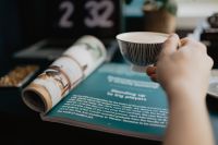 Kaboompics - Coffee Break with a Rolled Magazine Beside a Laptop