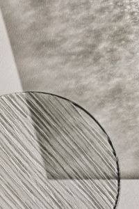 Kaboompics - Cropped Ribbed Glass Circle over a Soft Neutral Shadow Background