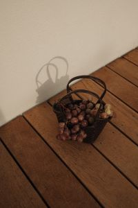 Kaboompics - Red Grapes in Basket on Wooden Floor