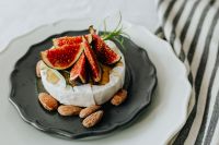 Kaboompics - Close-Up Camembert with Fresh Figs and Almonds on Black Plate