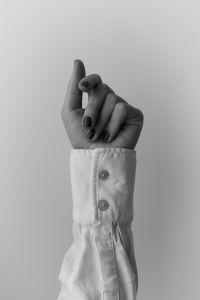 Kaboompics - Minimalist Hand Gesture With White Shirt Cuff