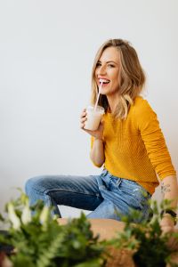 Kaboompics - Blonde Woman Drinking Through a Straw in a Yellow Sweater