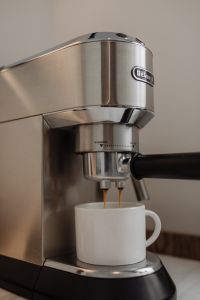 Kaboompics - Close-Up DeLonghi Espresso Extraction into White Mug