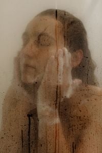 Kaboompics - Woman Showering Behind a Fogged Glass Door