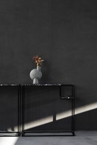 Moody Modern Living Room Interior Styling with Black Marble Console Tables, Sculptural Vases and a Leather Sofa