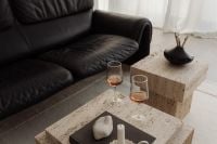 Kaboompics - Black Leather Sofa and Wine Glasses on Travertine Table