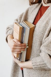 Cozy Reading Lifestyle with a Young Woman, Wool Sweater and Books