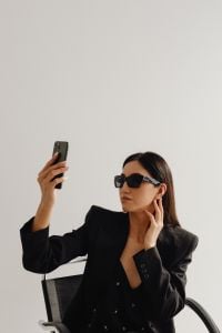 Kaboompics - Asian Businesswoman Taking a Smartphone Selfie in Sunglasses