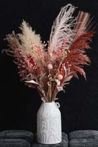 Kaboompics - Dramatic Dried Bouquet Against Black Wall With Gray Upholstery