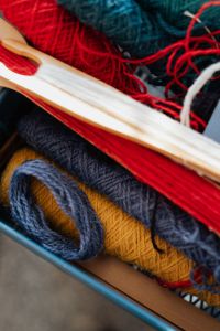Kaboompics - Blue and Red Yarn with Wooden Weaving Tools