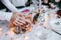Kaboompics - Hands Decorating a Copper Wire Basket with Pearl Garland