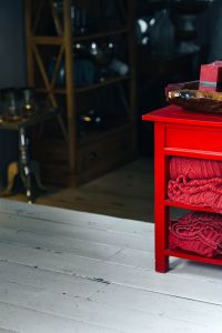 Kaboompics - Red woolen fabric stacked on a little red cupboard