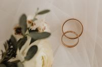 Kaboompics - Gold Wedding Rings Beside Soft-Focus White Blooms