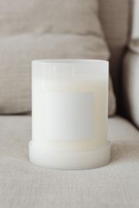 Kaboompics - Minimal White Candle Mockup with Blank Label on Neutral Couch