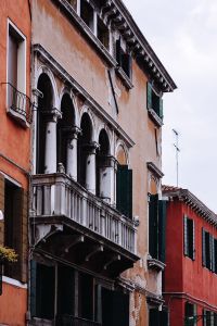 Kaboompics - Close-Up of Venetian Facade with White Arches and Dark Shutters