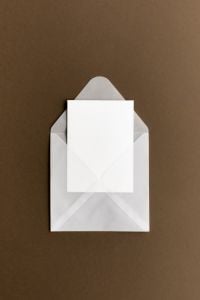 Kaboompics - White Envelope with Blank Card on Brown Background