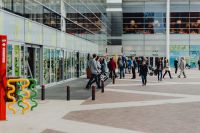 Kaboompics - Shoppers outside Manufaktura’s Modern Glass Shopping Centre Entrance in Łódź, Poland