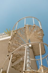 Kaboompics - White Cast Iron Spiral Staircase Against Blue Sky, Italy