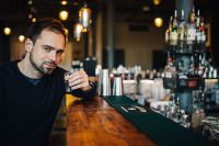 Kaboompics - Handsome young man drinking vodka at the bar