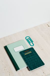 Kaboompics - Teal Calculator and Mint Notebook on Limestone for Modern Math Study and Classroom Content